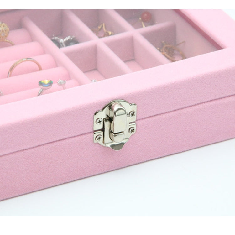 Close-up of pink jewelry storage box front clasp with flannel lining and compartments