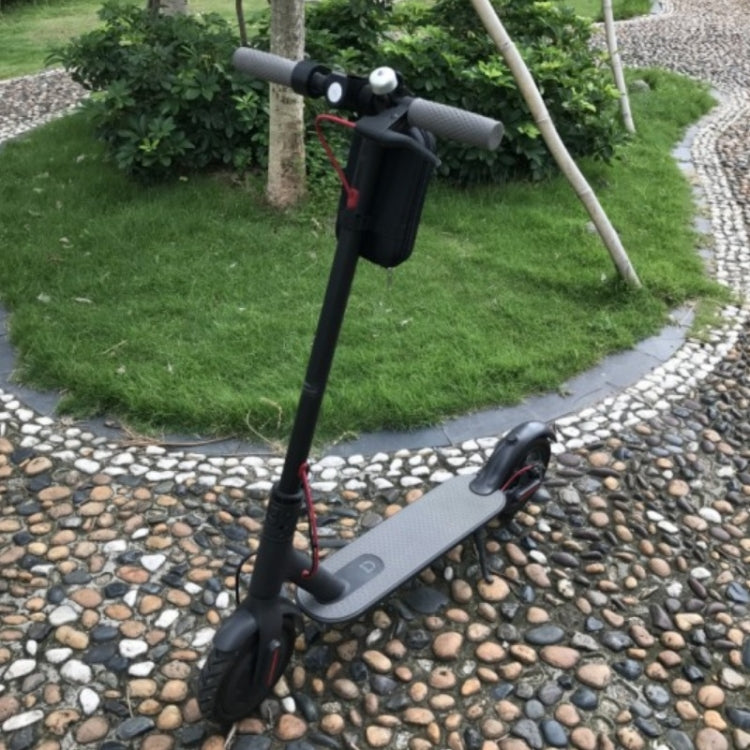 Mini front bike bag mounted on scooter handlebar on an outdoor path.