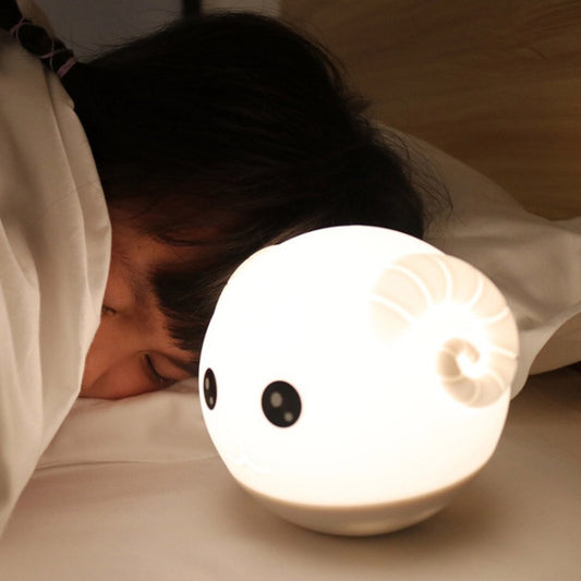 Soft white silicone animal night light with glowing round face, black eyes, and smile