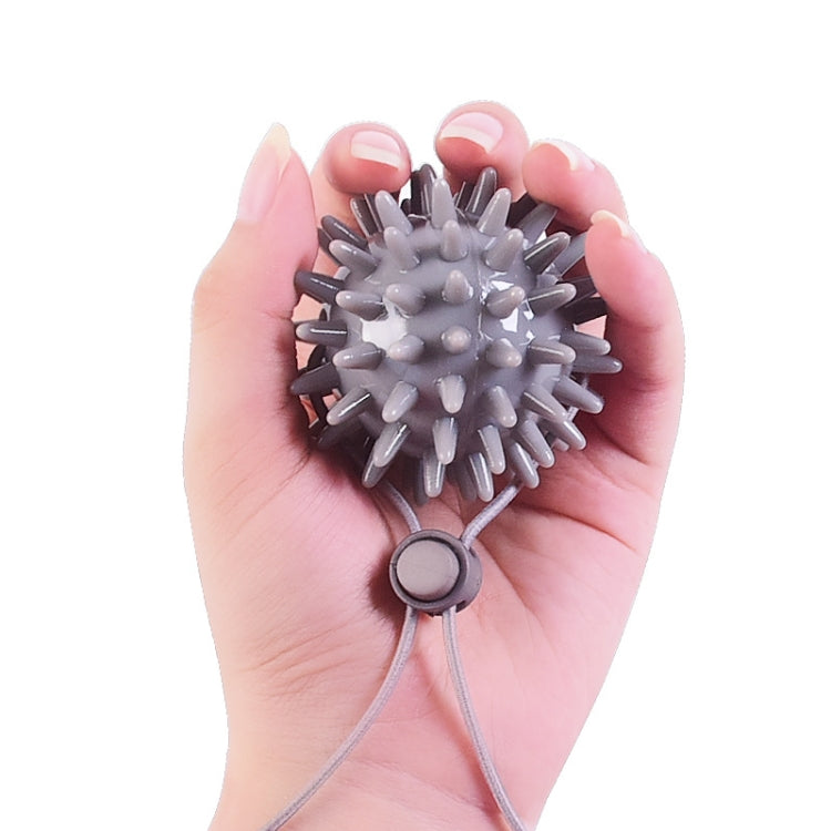 Gray spiky finger massage grip ball with gray rope strap for rehab therapy