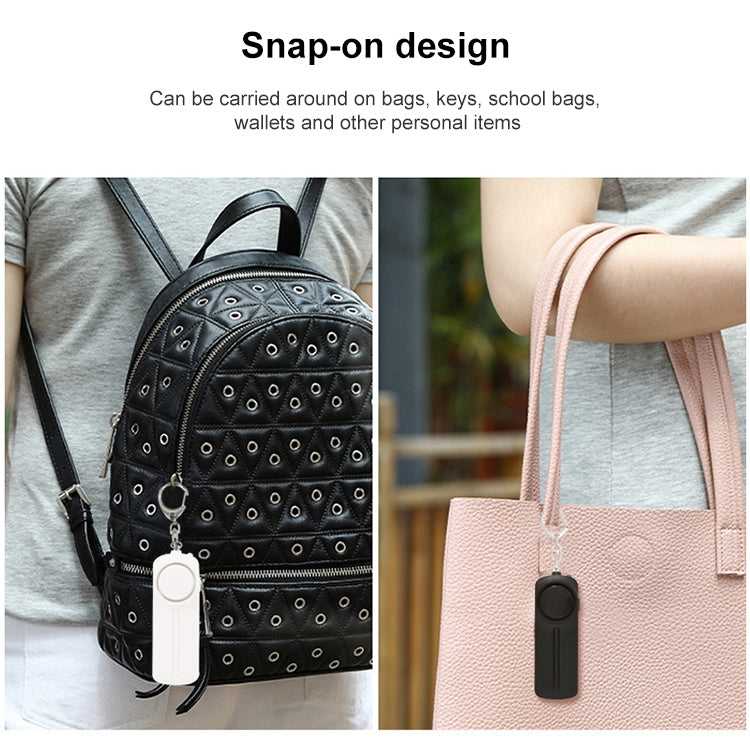 Black alarm keychain clipped to backpack strap and carried on a tote bag