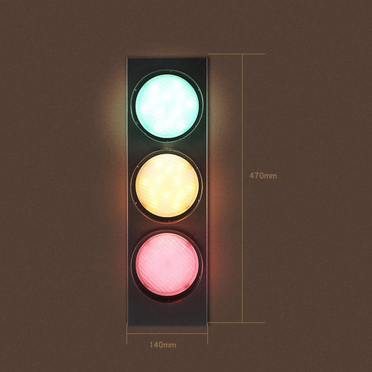Black traffic light wall lamp with three circular lenses glowing green, amber, and pink