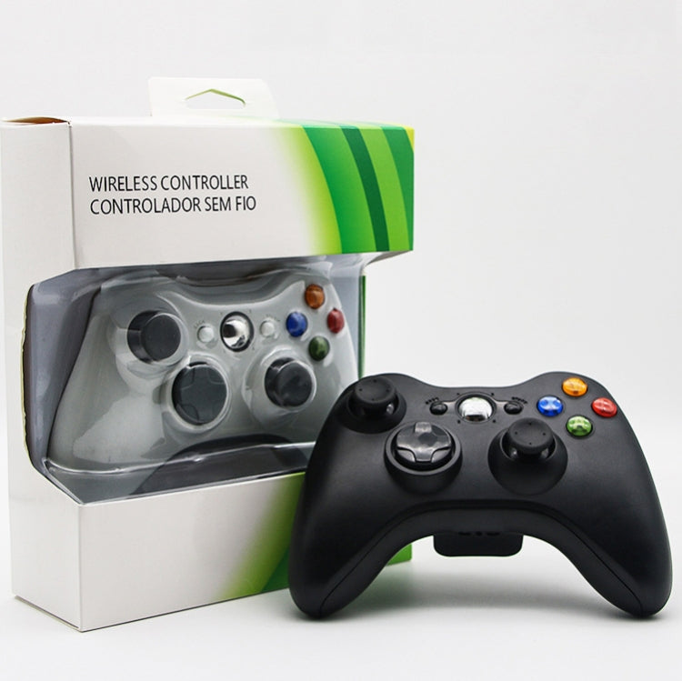 Black wireless game controller with USB cable beside retail box