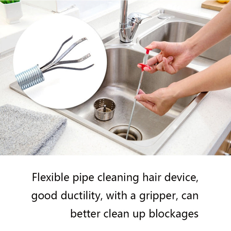 Flexible drain cleaning hair tool with red grip handle and spring cable near sink