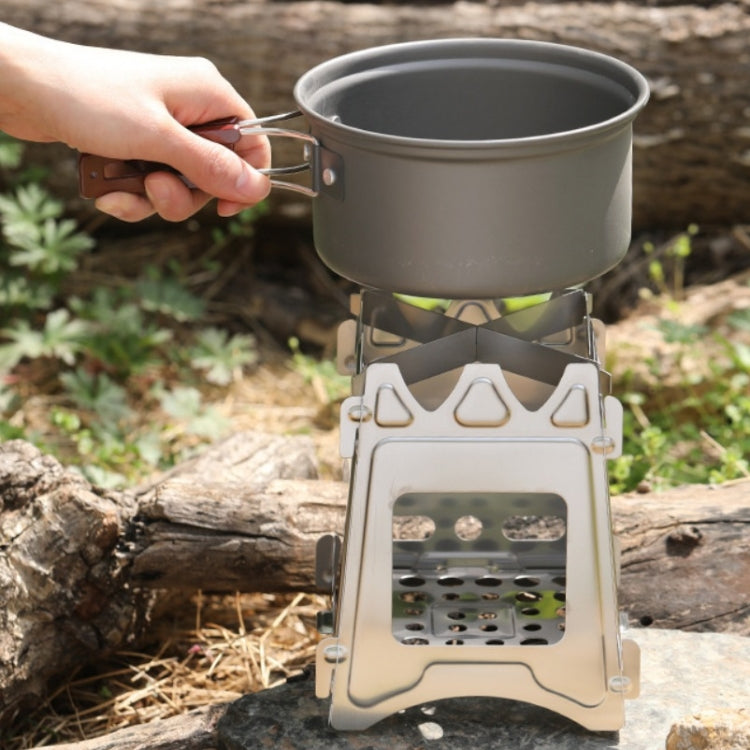 Foldable stainless steel camping stove with pot on top over the burner grate