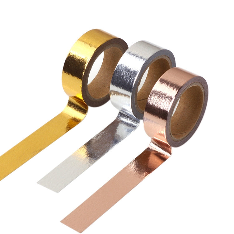 Unrolled metallic decorative tape strips in gold, silver, and rose gold colors