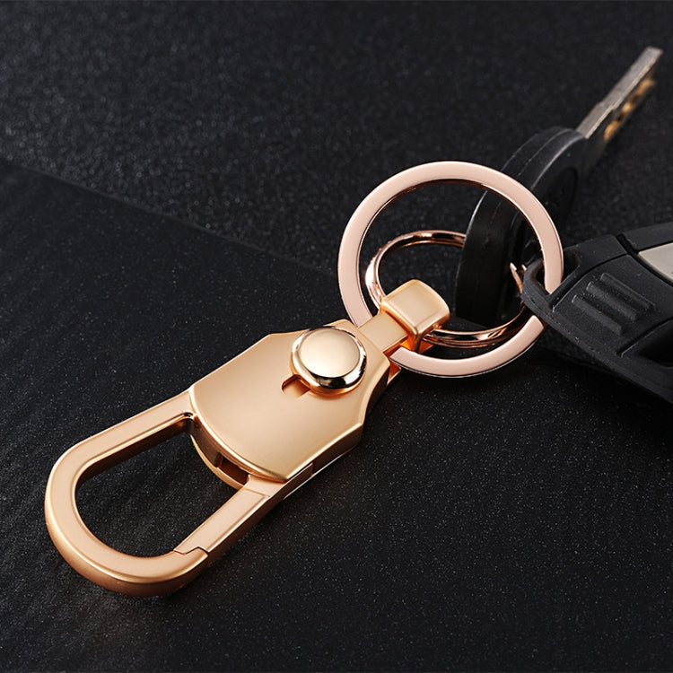 Golden car keychain attached to a black car key with double-ring loop