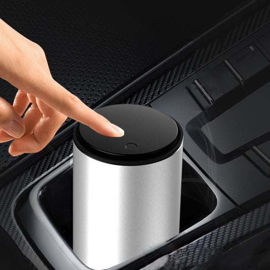 Silver metal car trash can with black flip lid, hand pressing the top