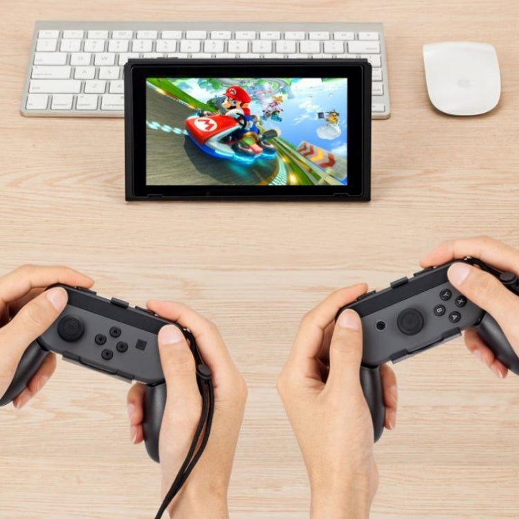 Hands holding Nintendo Switch controller grips attached to Joy-Con controllers