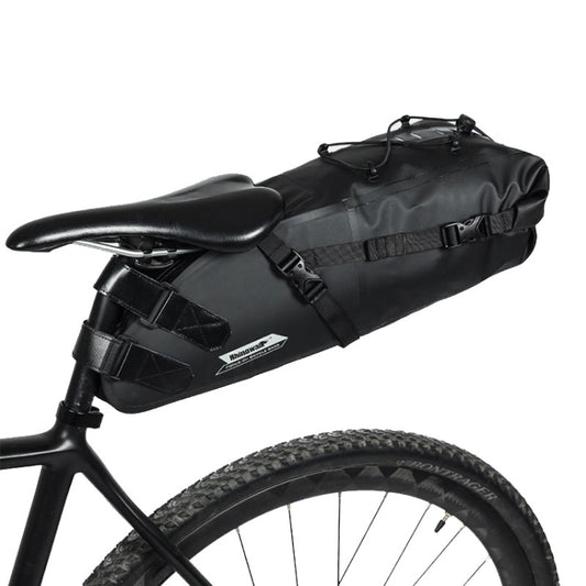 Black waterproof bicycle saddle tail bag with straps and top roll closure, mounted on bike