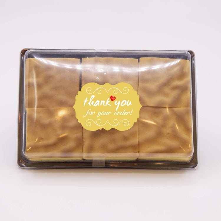 Thank you order sticker label on a gold package, yellow scalloped design