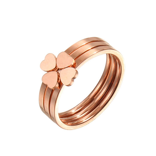 Rose gold tone three-band ring set with peach four-leaf clover heart charms