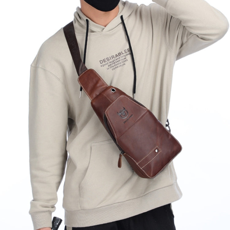 Brown leather crossbody chest bag worn on the front with adjustable shoulder strap