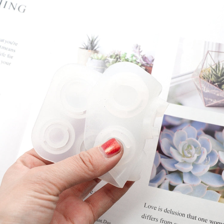 Hand holding a white silicone ring mold with multiple round ring cavities
