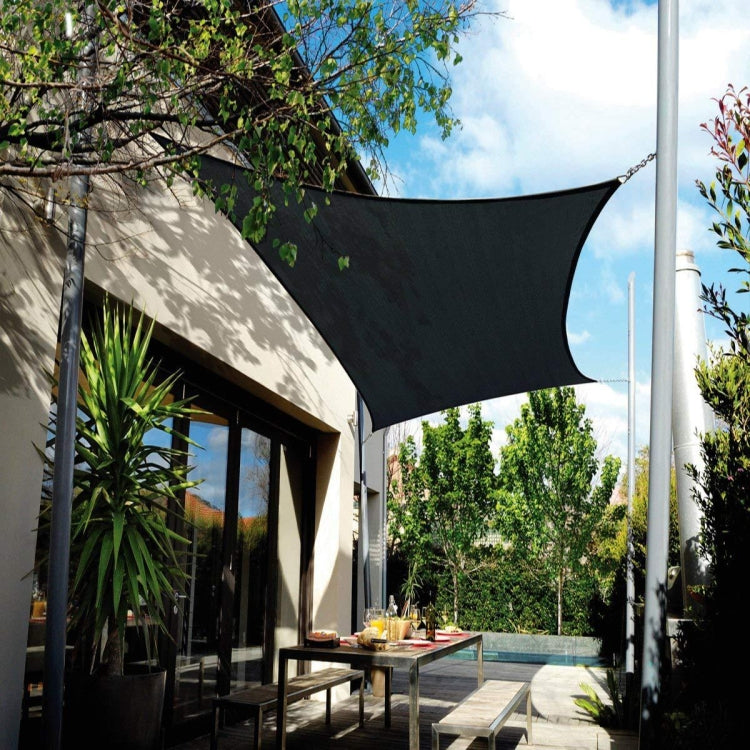 Black rectangular shade sail canopy attached above an outdoor seating area