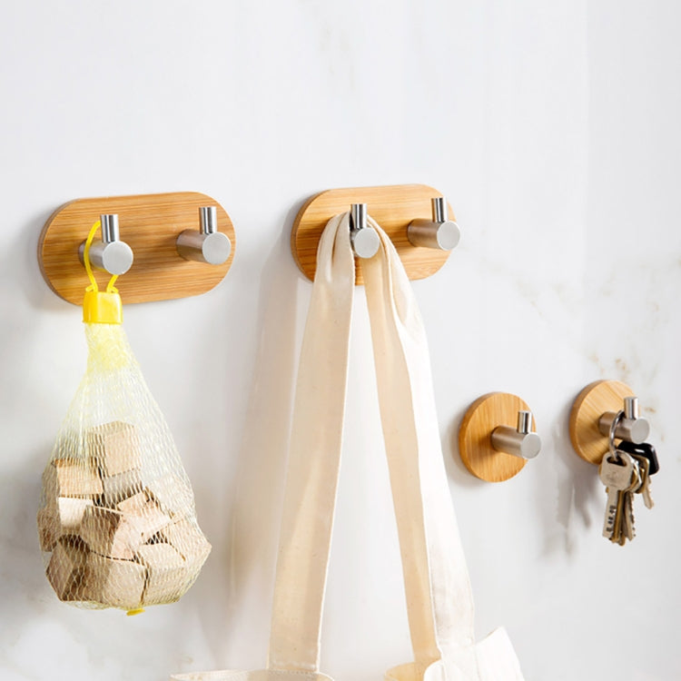 Bamboo adhesive hooks on wall with stainless steel ends for hanging keys and towels