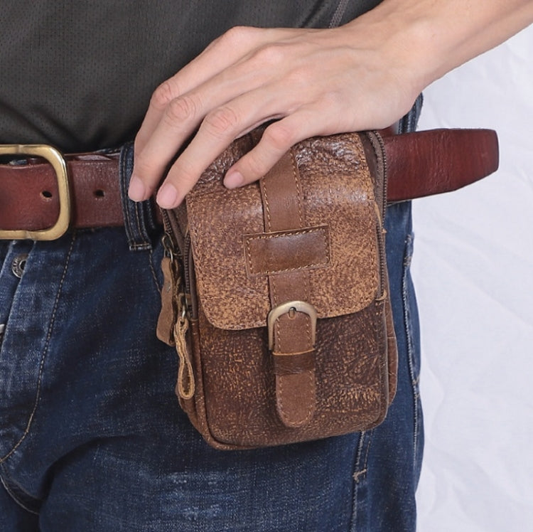 Men's brown phone belt bag worn on waist, with flap closure and metal buckle