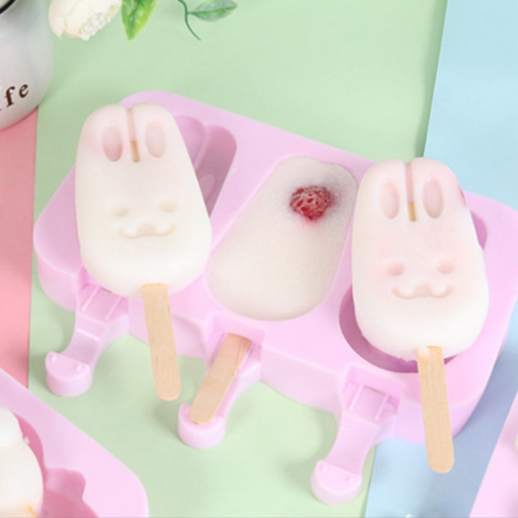 Rabbit-face popsicles in pink silicone mold with lid, one pop with strawberry center