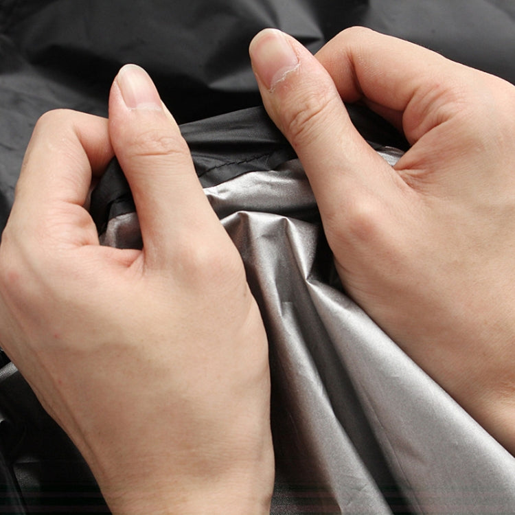 Hands adjusting black outdoor air heater cover fabric with smooth waterproof surface