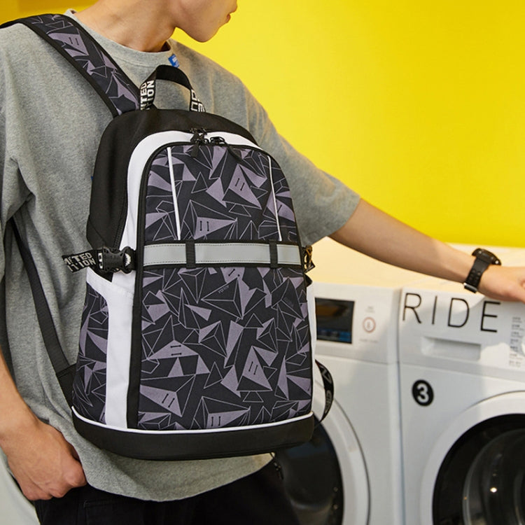 Geometric black and white backpack worn on shoulder with front zipper pocket