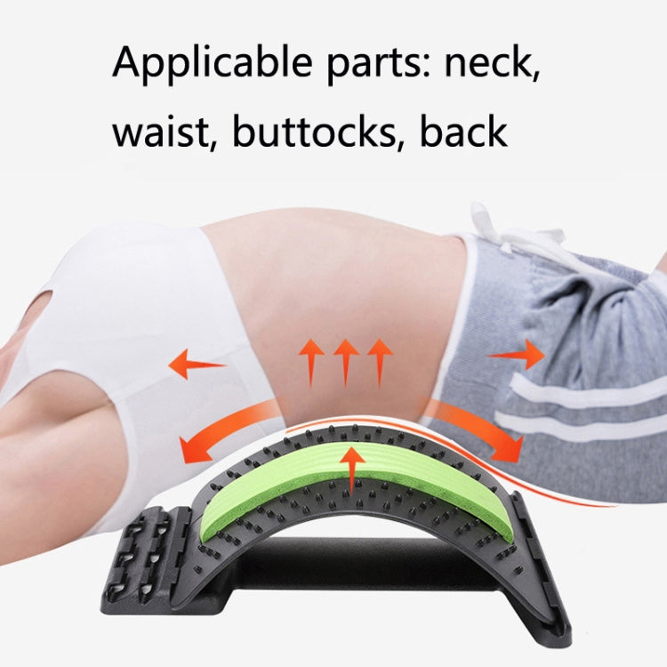 Lumbar disc stretcher worn on lower back, black brace with lime green arc pad