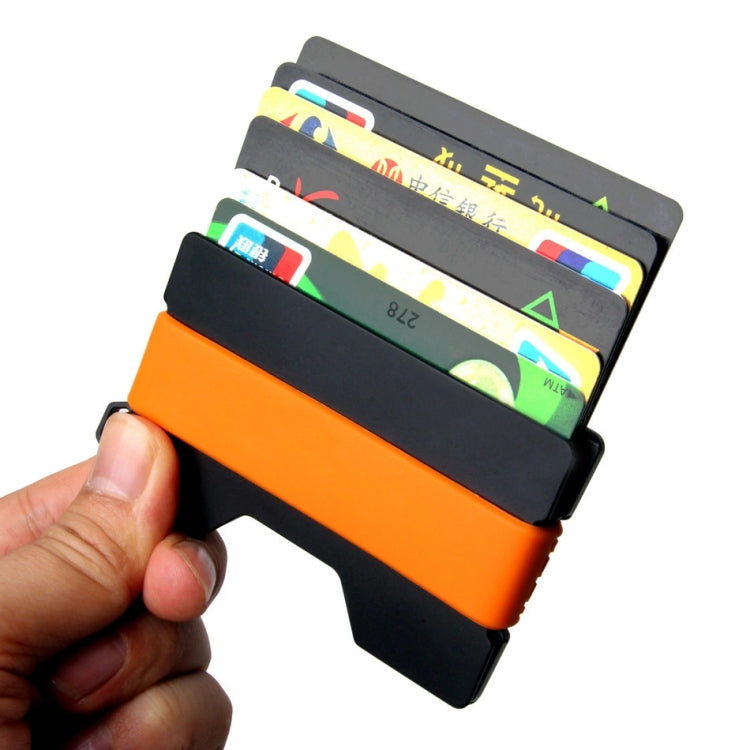 Orange and black RFID card holder held in hand with multiple cards visible