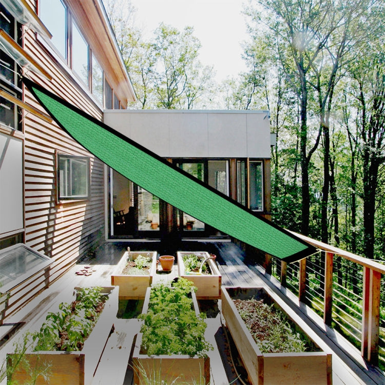Green balcony shading net stretched along a terrace walkway beside railings