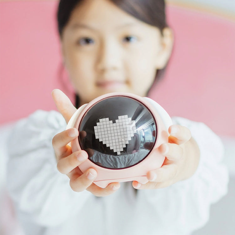 Child holding a pink cartoon digital alarm clock with oval LED display