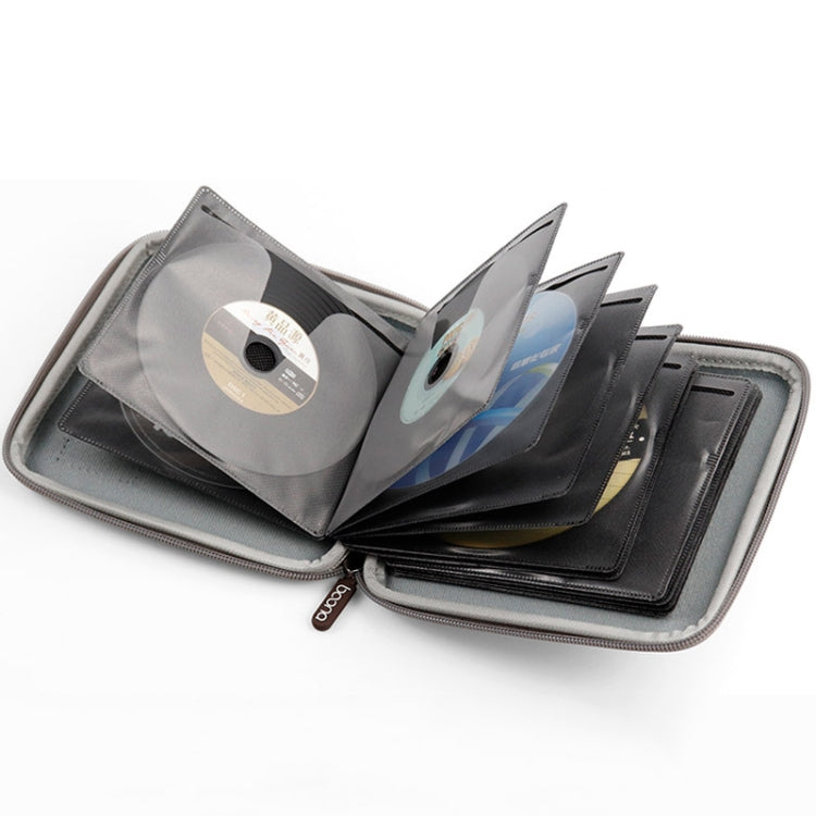 Open CD storage bag with clear sleeves holding multiple discs and cards.