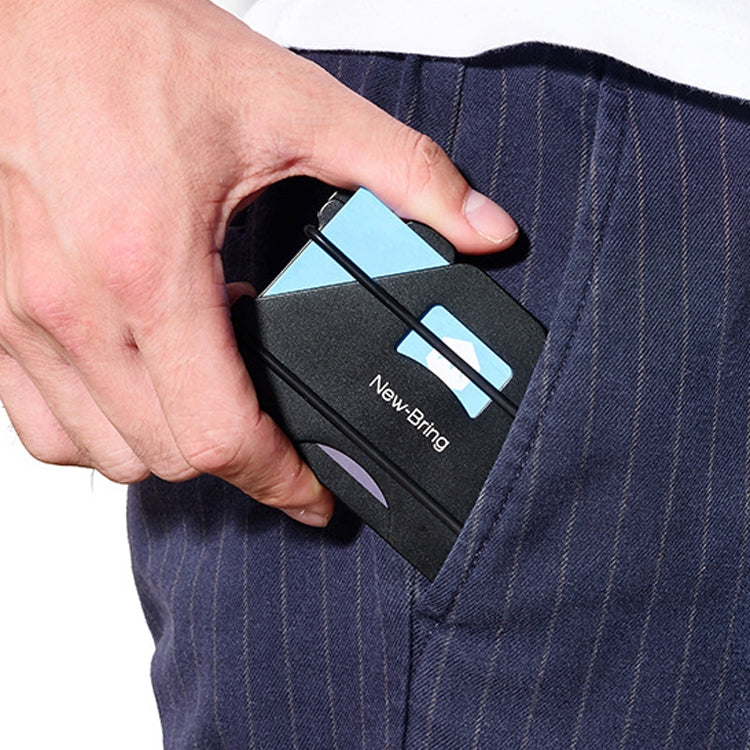 Black metal RFID card holder in back pocket with cards partially inserted
