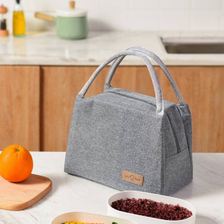 Gray insulated lunch tote bag with leather label and sturdy carry handles