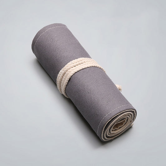 Gray fabric pen roll organizer with off-white cord wrap and folded base