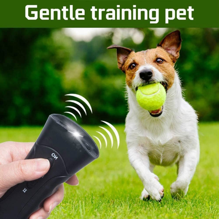 Black handheld ultrasonic dog repeller flashlight held near a dog with ultrasonic wave icons