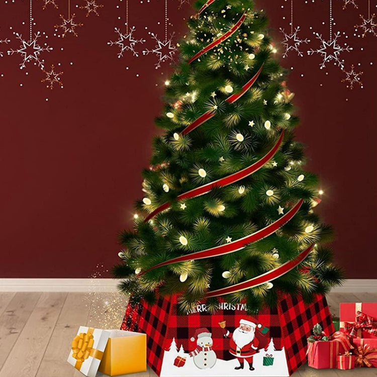Decorated artificial Christmas tree with red ribbon garland and white lights