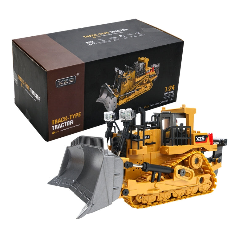 Boxed remote-controlled crawler bulldozer toy with gray blade and yellow tracked body.