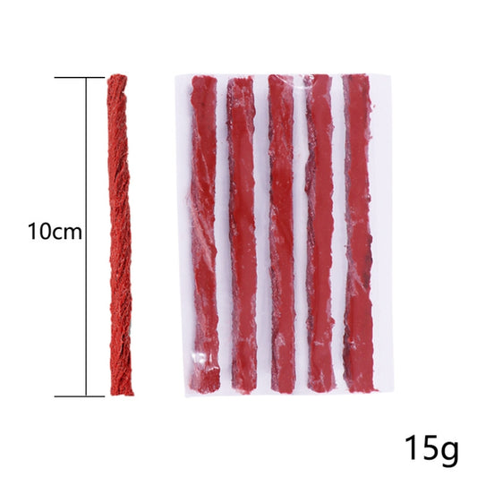 Red tire repair strip set on plastic sheet, narrow sealing strands