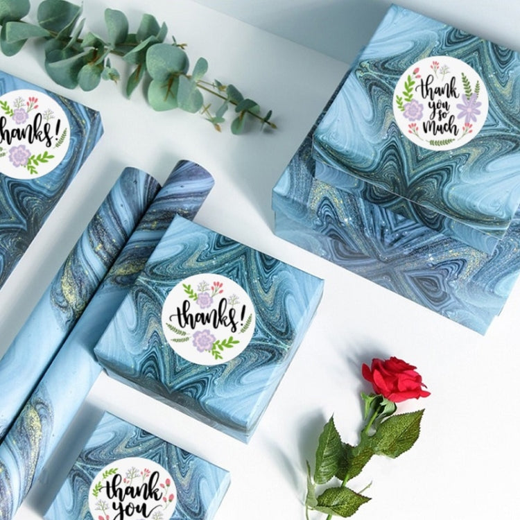 Floral thank you stickers applied to blue gift boxes and wrapped items