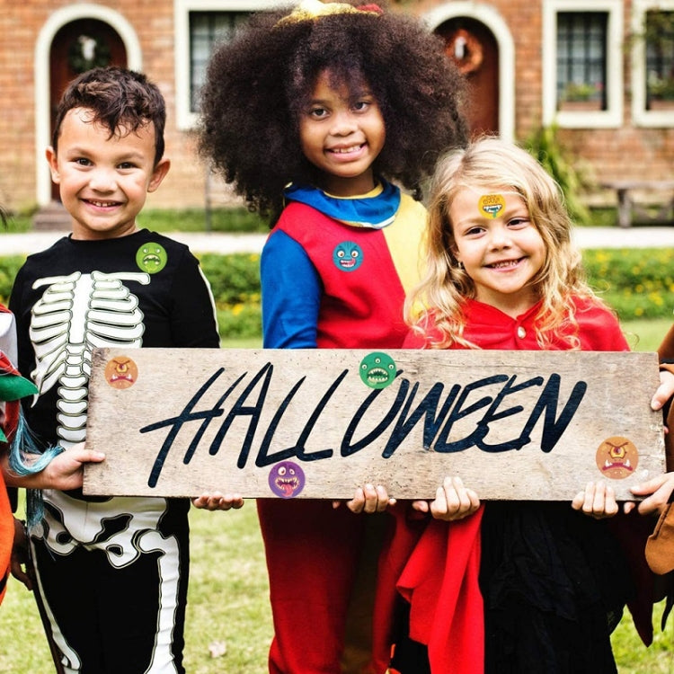 Halloween pumpkin monster sticker craft on wooden sign held by children