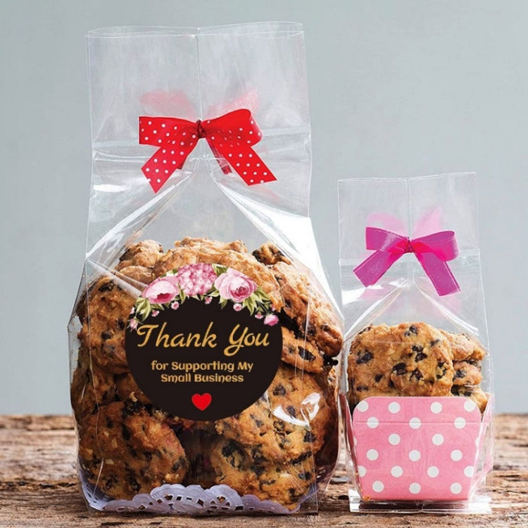 Round “Thank You” sealing sticker on clear gift bag with cookies and pink ribbon