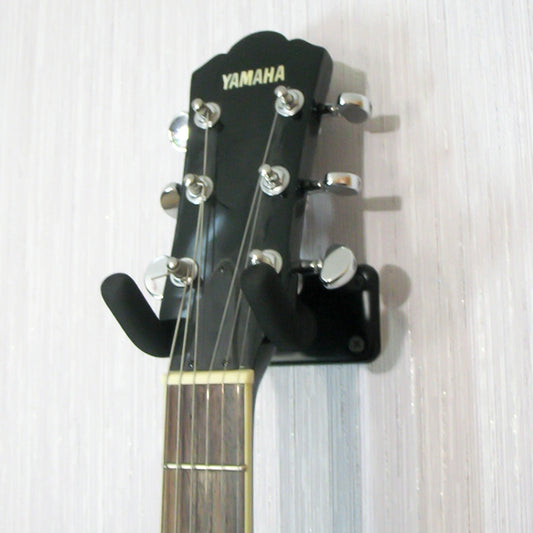 Metal wall hook with black sponge U-shaped cradle holding a guitar head