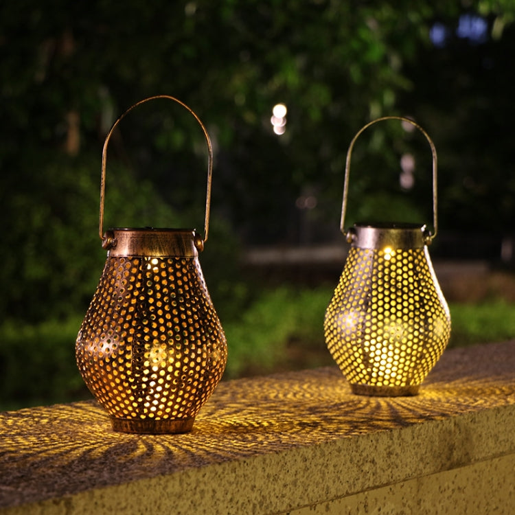 Copper perforated metal solar LED lanterns on outdoor step with golden dot glow