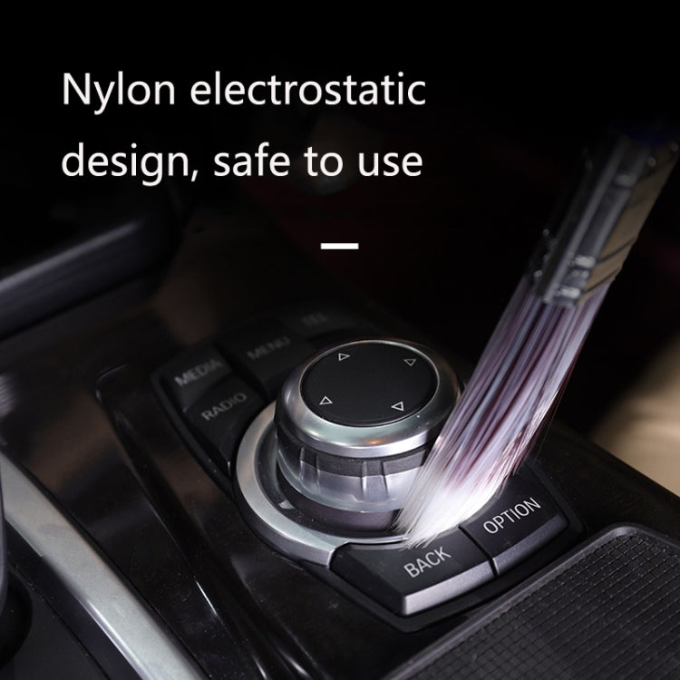 Car AC control area with blue cleaning brush bristles beside the knobs