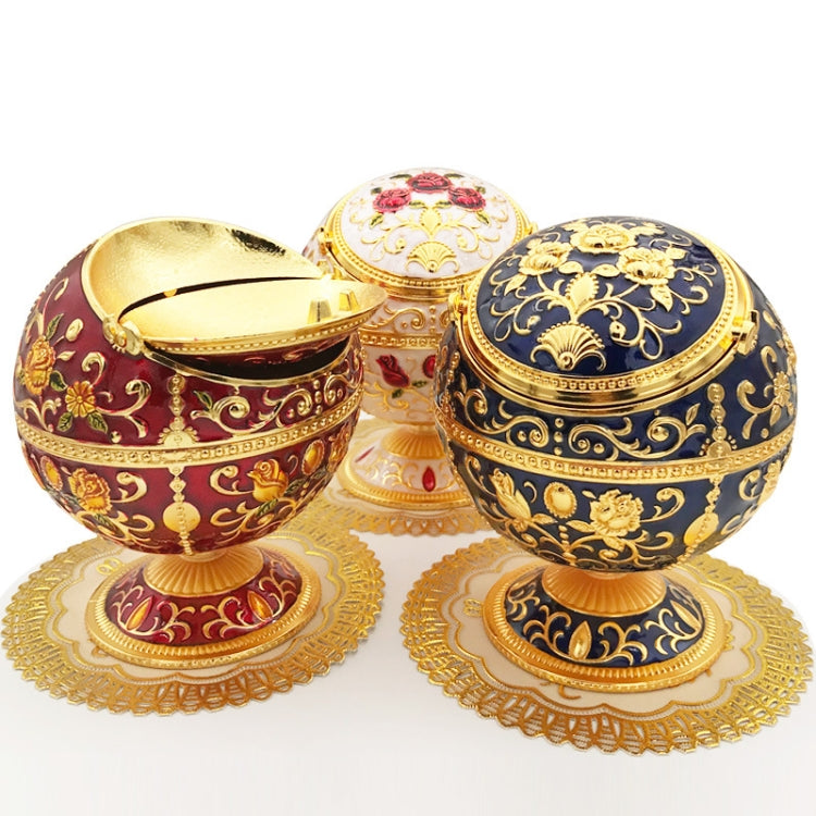 Three decorative globe ashtrays with hinged lids, ornate gold filigree on red and blue shells