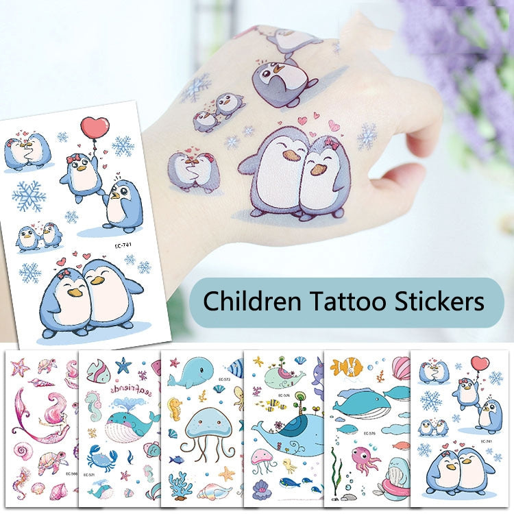 Children tattoo sticker set with blue penguins and hearts, held in a hand