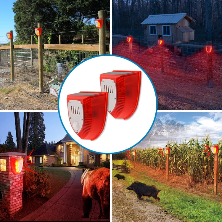 Solar animal repeller alarm units wall-mounted outdoors, showing red glowing light