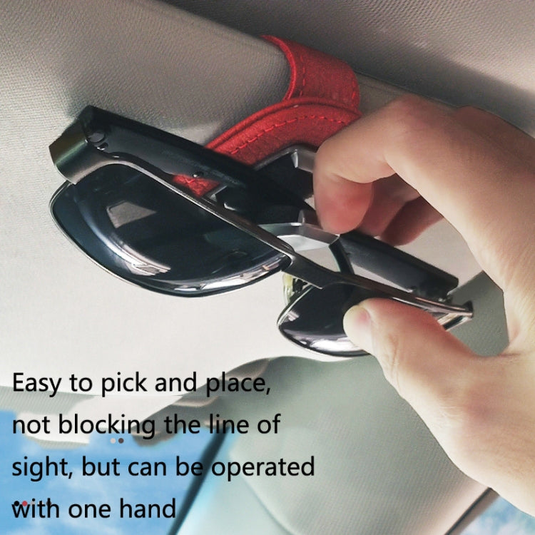 Hand attaching a black sun visor glasses clip holder to sunglasses