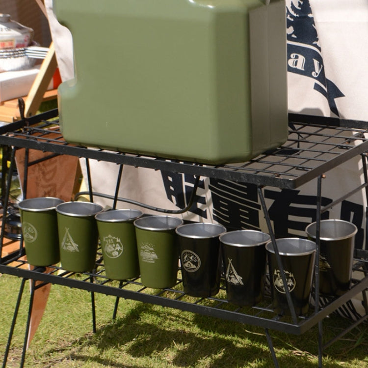 Stainless steel camping cups in green and silver on folding grill rack