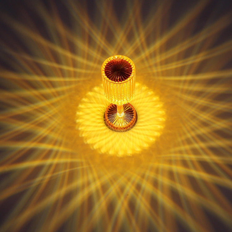Amber glowing crystal table lamp with faceted cylindrical acrylic shade