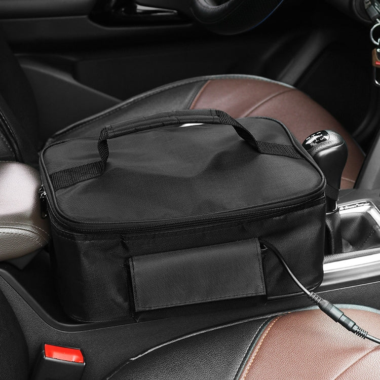 Black heated lunch box bag with front pocket and connected power cord on car seat