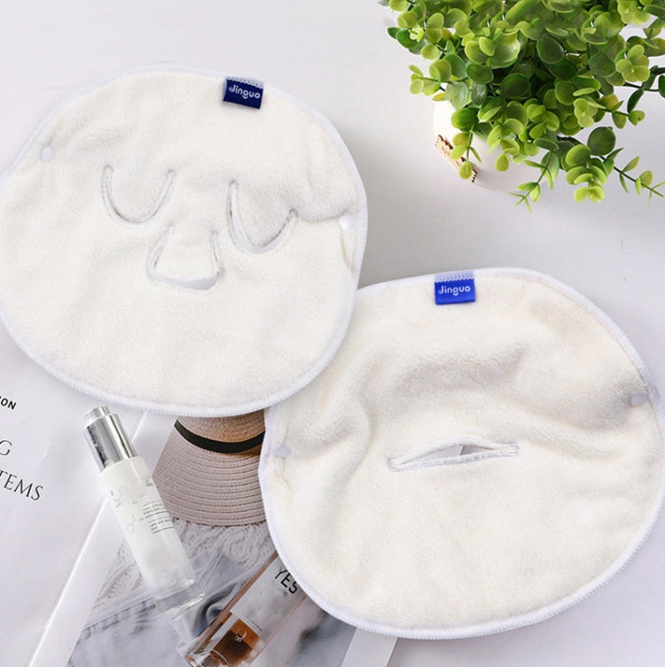 White plush facial compress towel mask pair with face openings, laid flat for use
